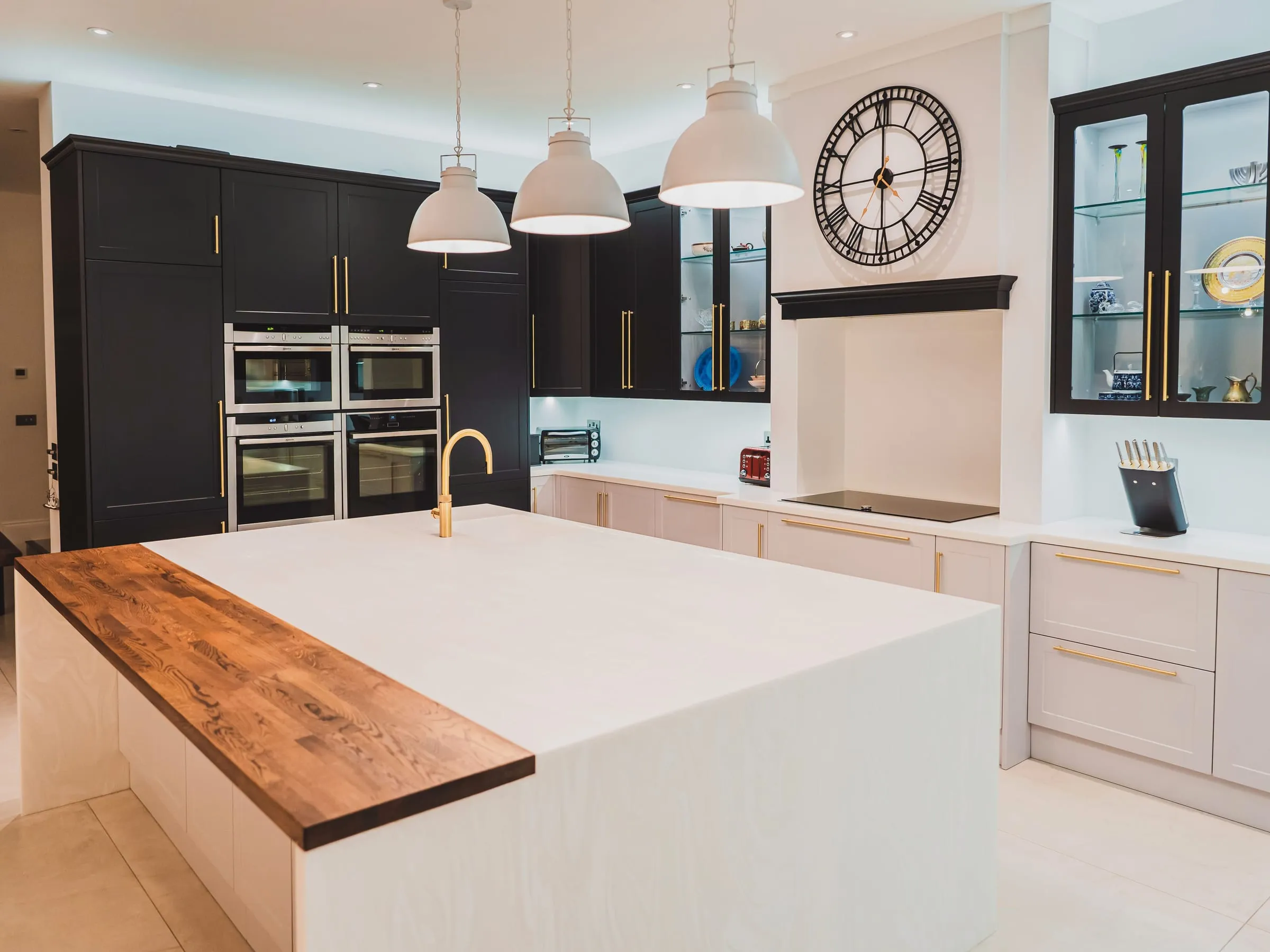 Oak-topped kitchen island with a white solid-surface waterfall edge