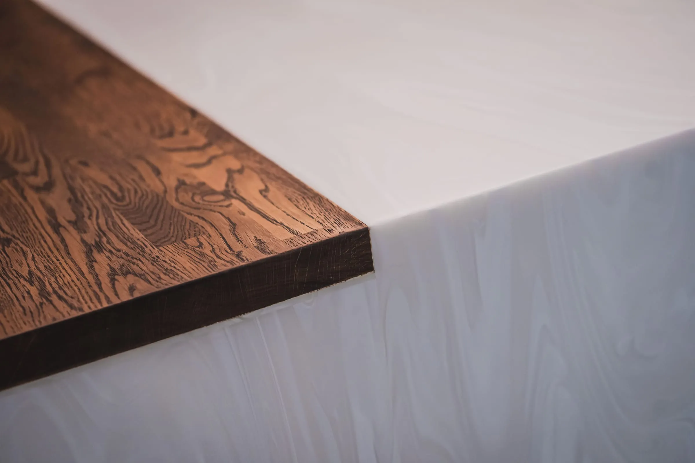 Oak and white solid-surface edge detail on a kitchen island