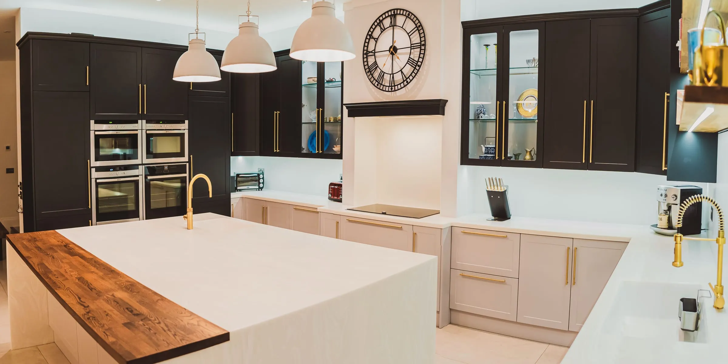 Navy shaker kitchen with brass handles and an oak-topped island
