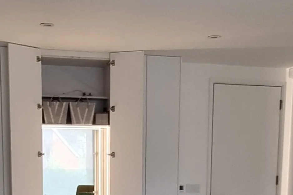 Fitted wardrobes with a built-in dressing area in a modern bedroom