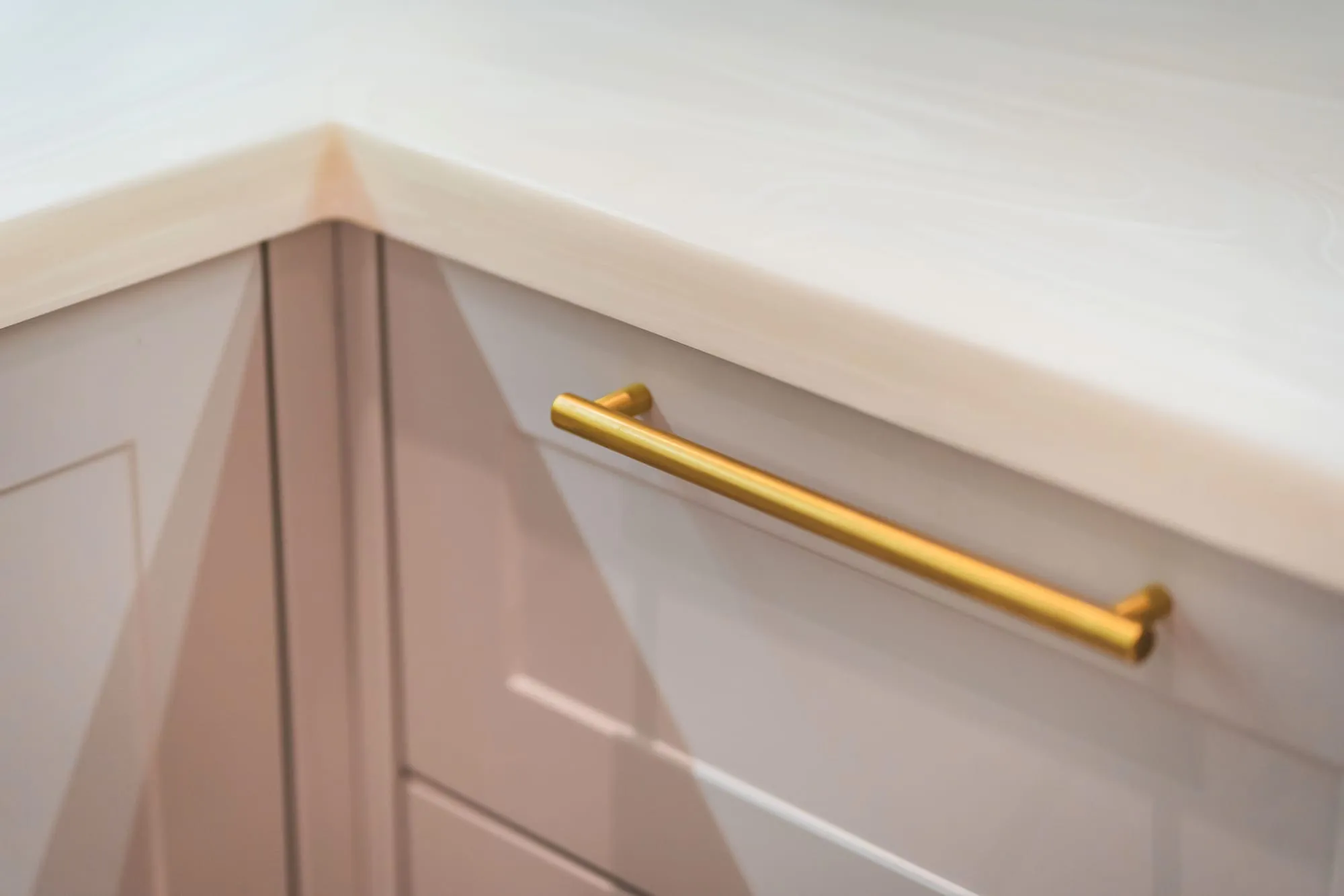 Brass handle detail on painted shaker kitchen cabinets